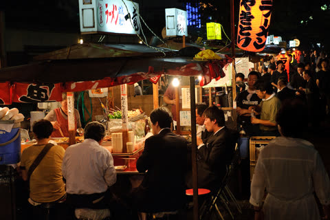 People eat at nighttime food stalls.