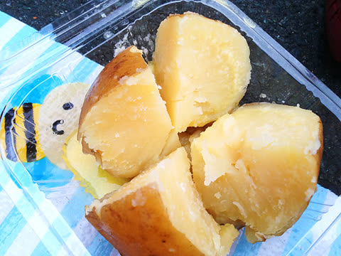 Baked potato cut into pieces in a clear plastic container.