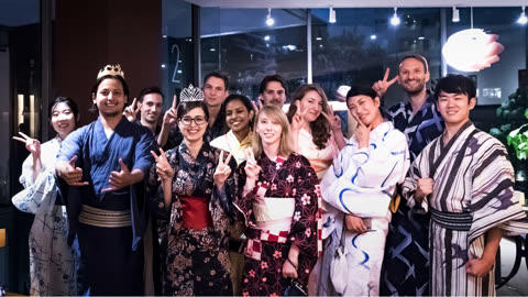 Group wearing yukatas poses indoors.